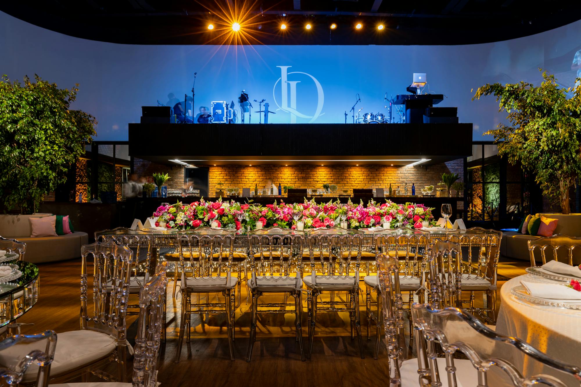 Decorated reception with floral runner and stage backdrop
