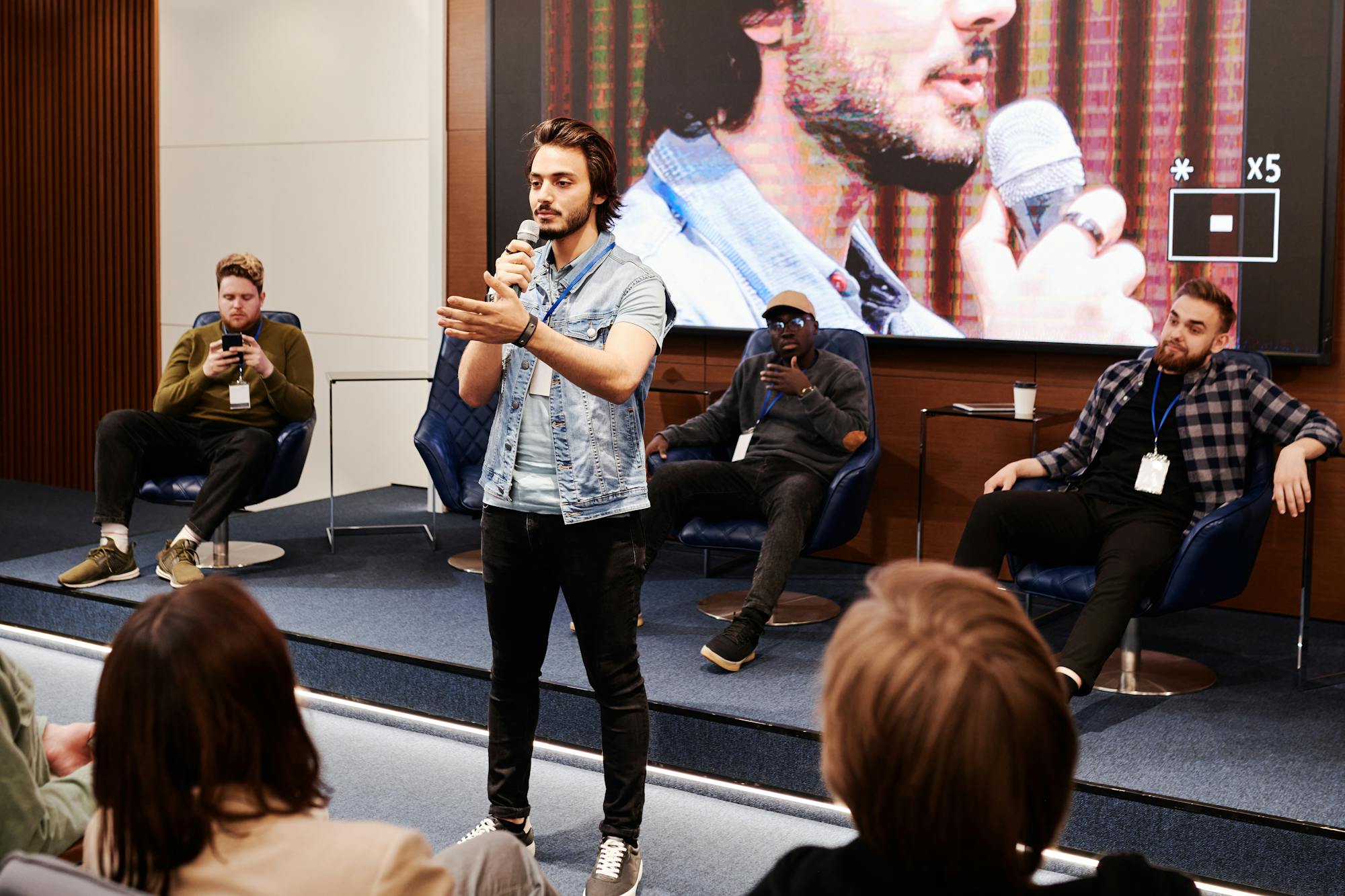 Speaker on stage at a corporate panel discussion
