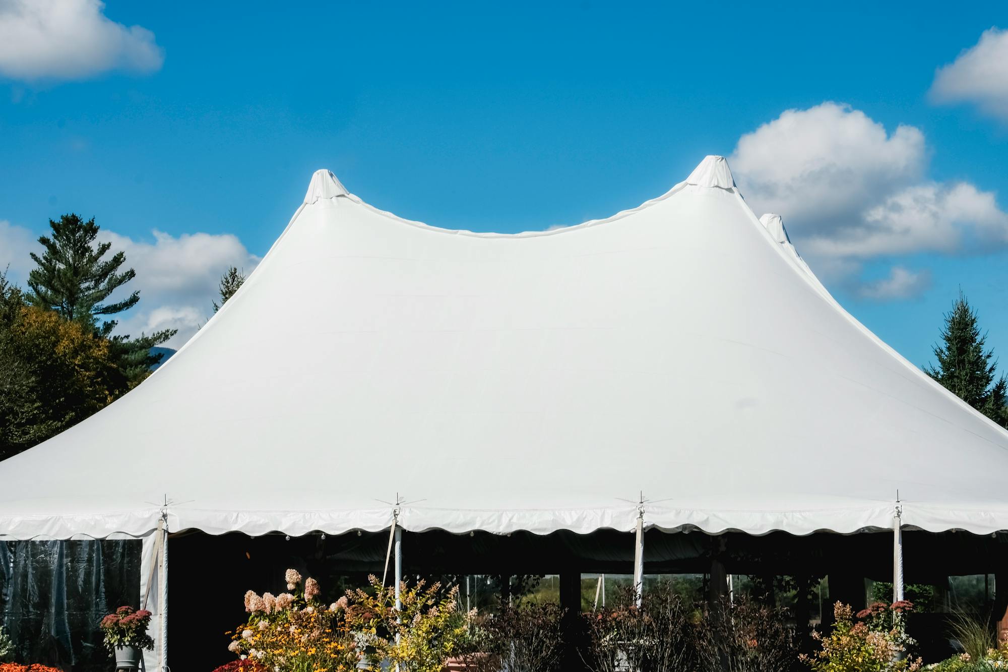 Large white event tent set up outdoors for a private function