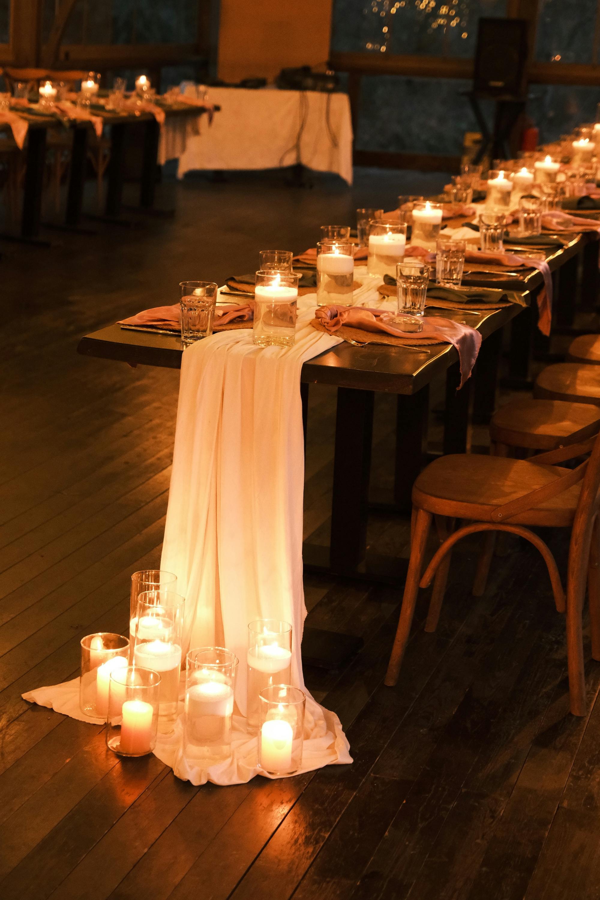 Wedding table with chiffon runner and floor candles