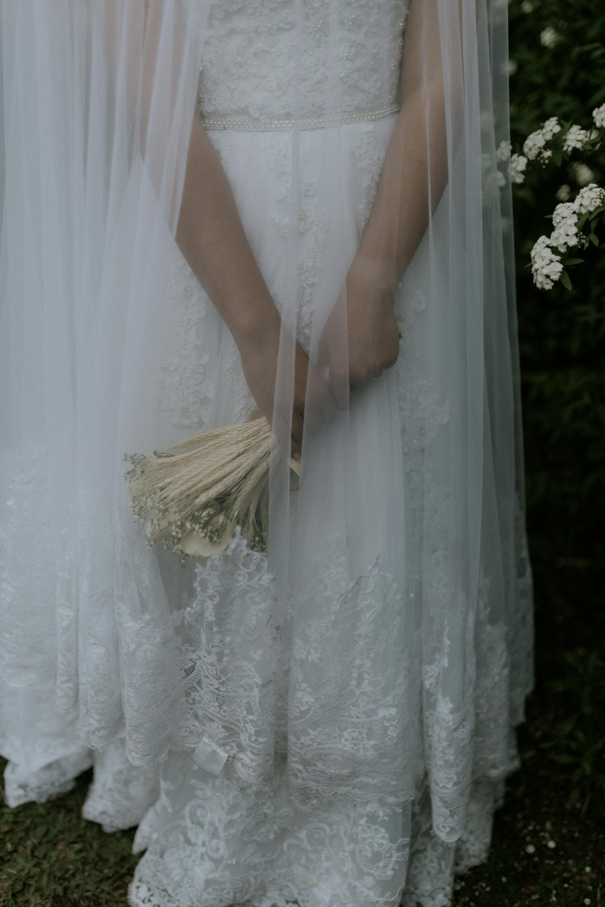 Bride in lace gown holding a bouquet