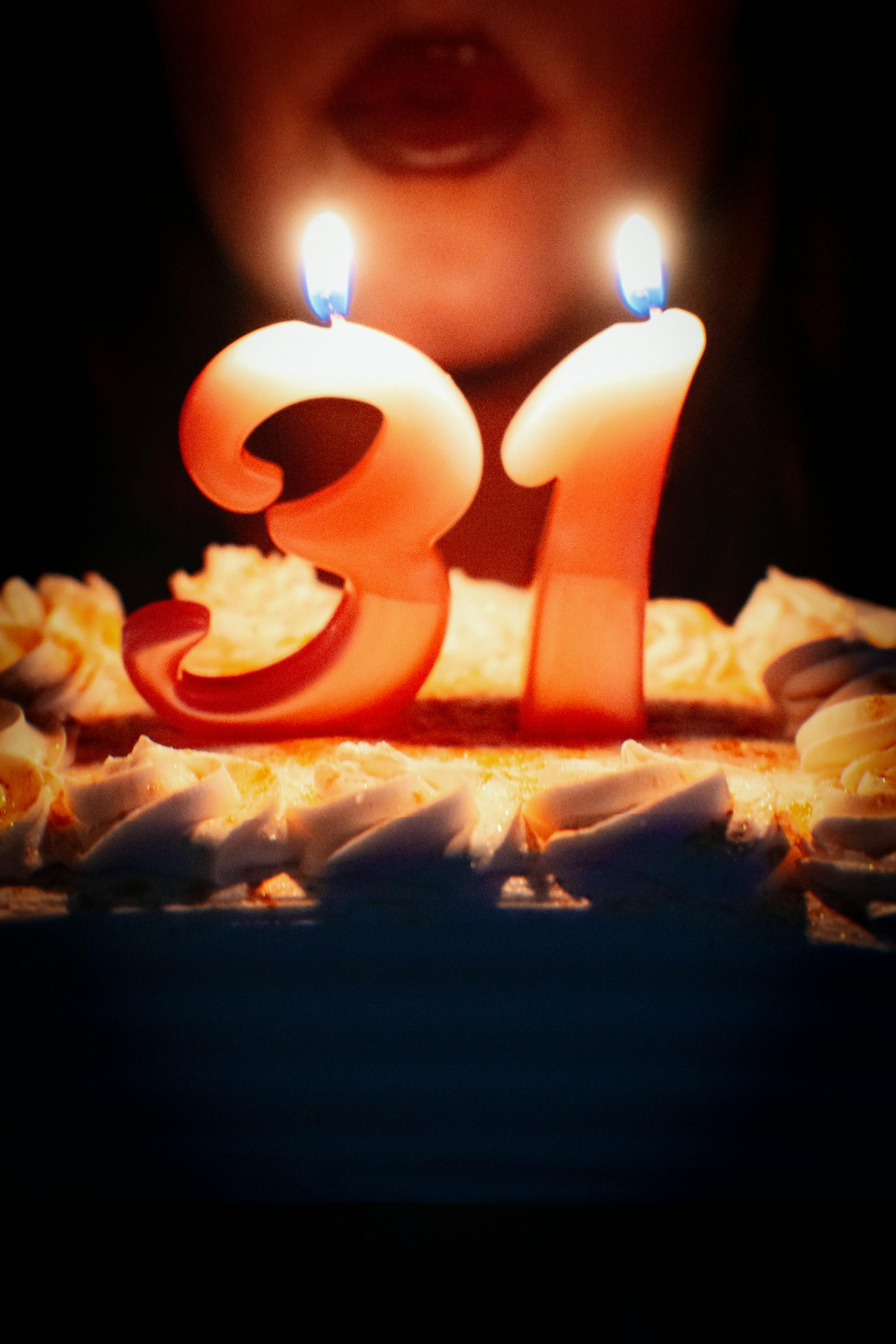 Close-up of a birthday cake with lit candles
