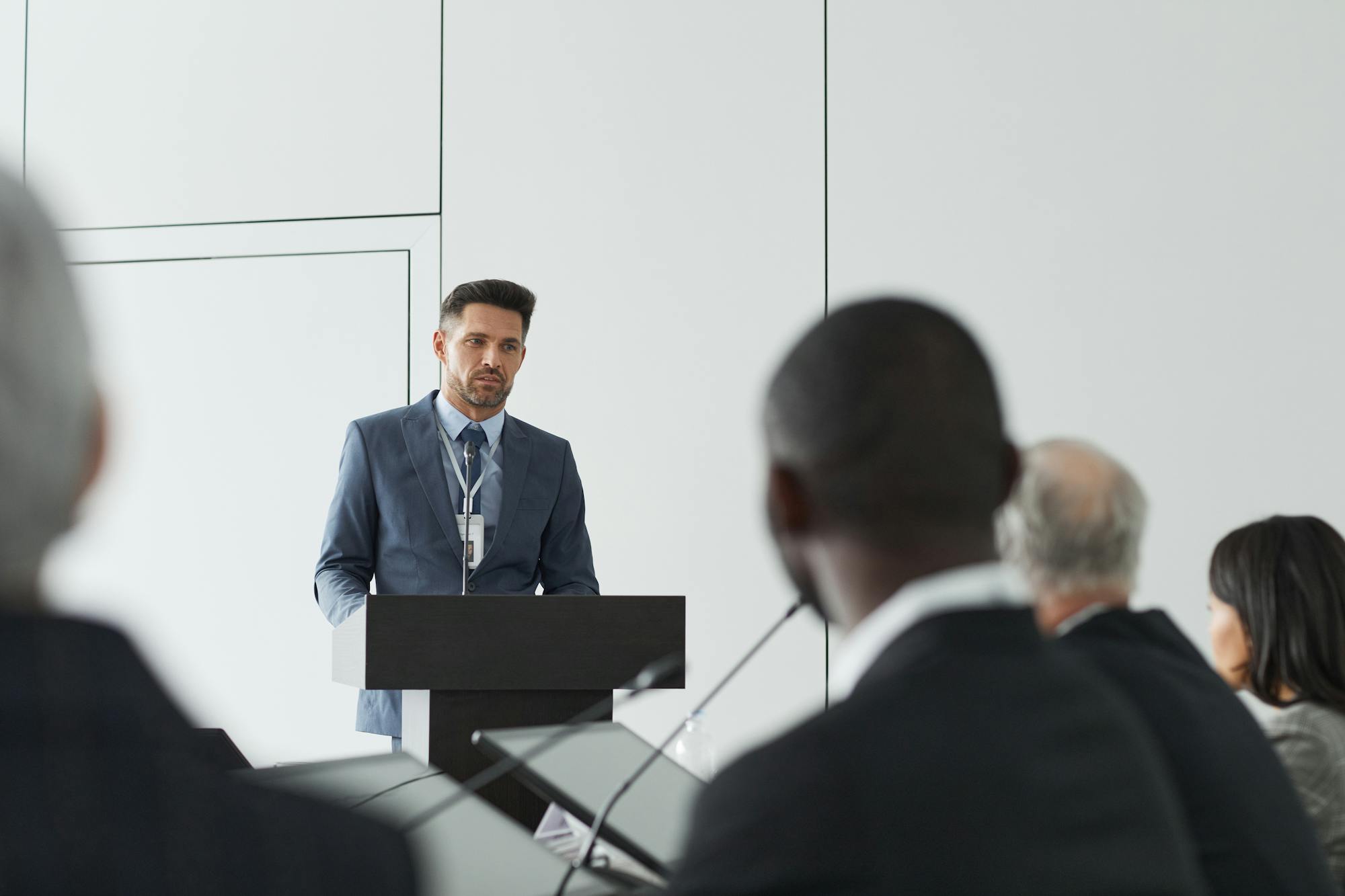 Business speaker at a podium addressing an audience